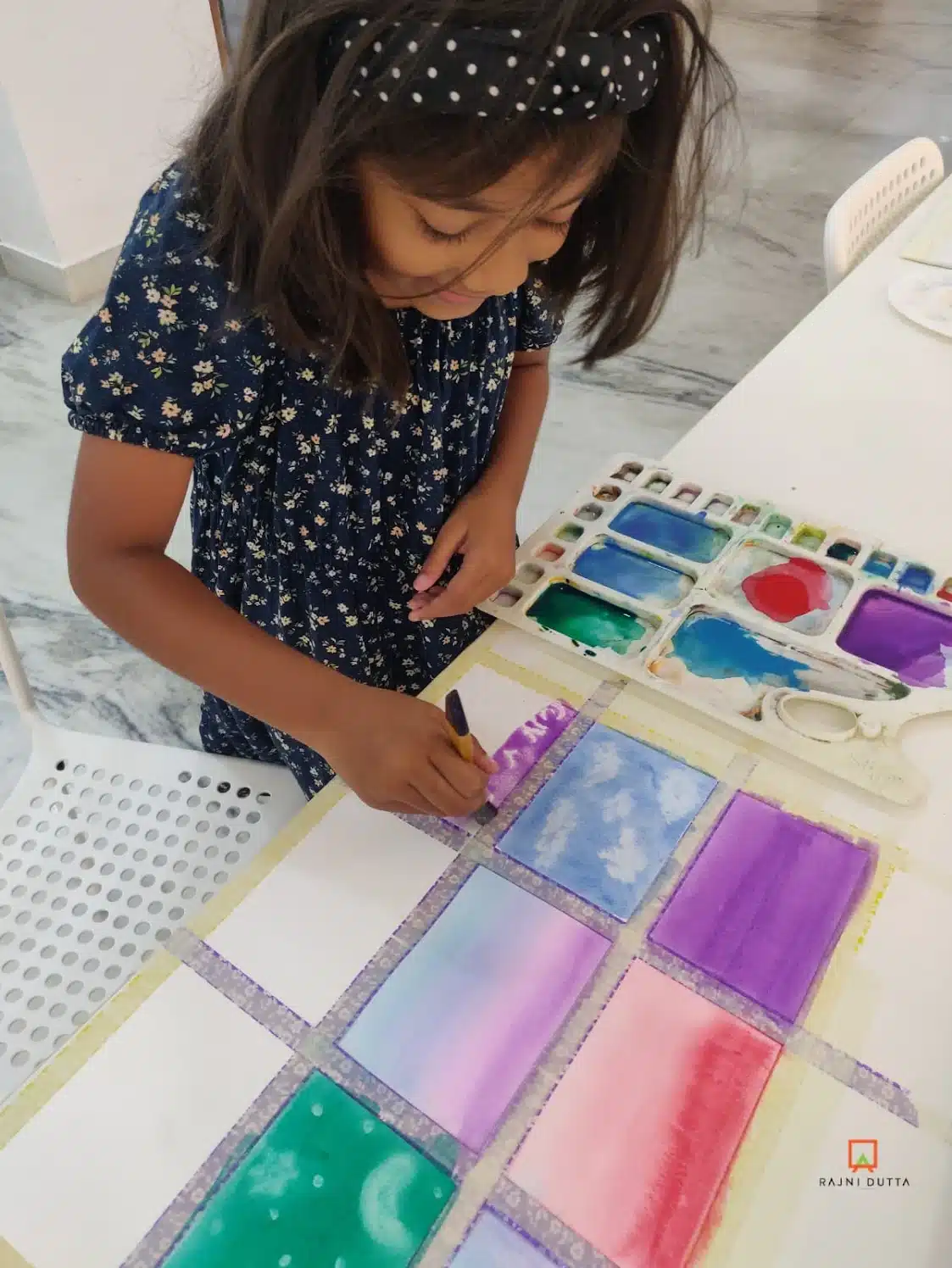 Close-up of a child's artwork in progress at RDAD studio